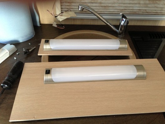 Both light fittings attached to the panels with tubes and diffusers installed